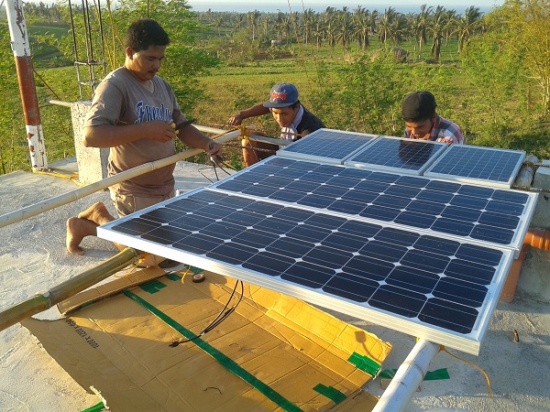 With power knocked out by Typhoon Glenda from San Miguel for perhaps 1 year, both of our radio stations have to run fully on solar power.  Here Than, Nho, and Jonel are wiring up the panels to our resurrected San Miguel station.