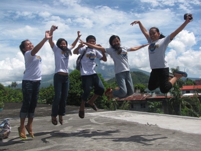 Happy campers jumping up in front of Mayon.