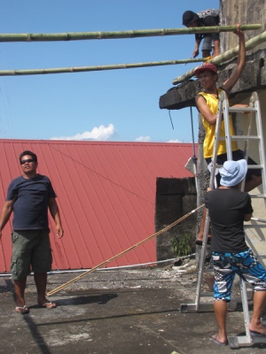 Jonathan, our main project guy on the islands, overseeing construction of outside tent at new center.